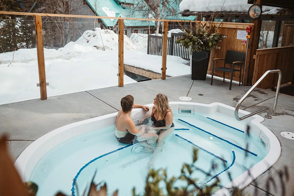 Couple in the new hot tub at Emerald Lake Lodge in Field, BC Canada